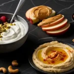 healthy snack alternatives to junk food including yogurt berries nuts and hummus in dramatic lighting