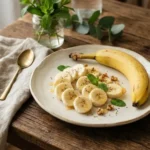 Sliced banana on cream plate, wooden background, soft natural light, editorial food photography, banana nutrition facts